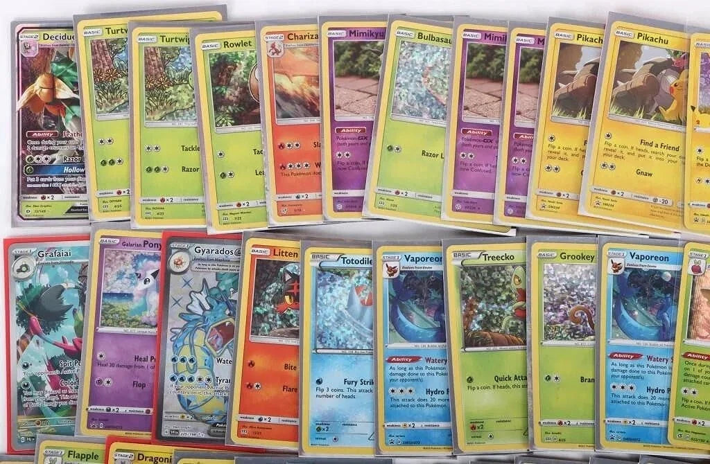 Assorted 25 Pokémon trading cards featuring rares, holos, energy, and trainer cards for collectors and kids
