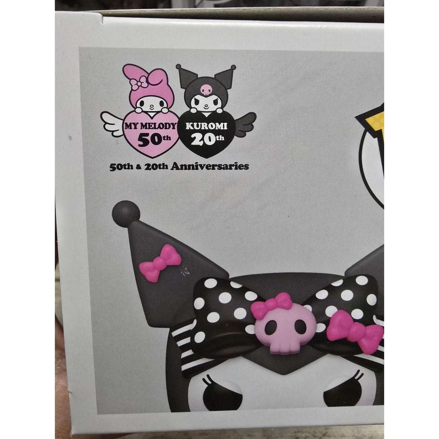 Sanrio Kuromi 20th Anniversary Funko Pop! vinyl figure with pink and black polka dot bow and skull accessory on packaging box