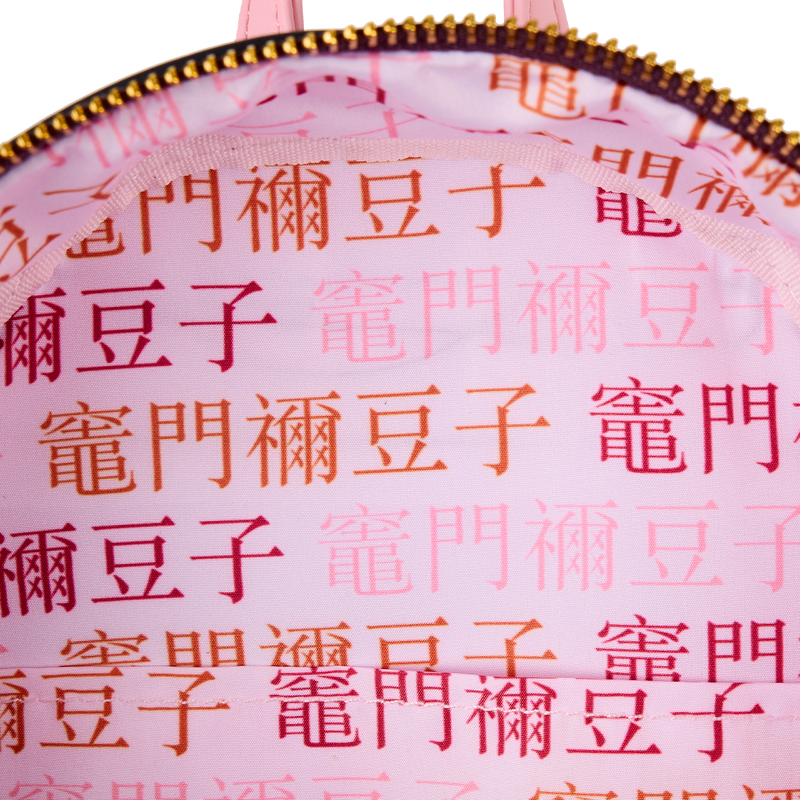 Interior view of Loungefly Demon Slayer Nezuko Kamado mini backpack showing pink fabric lining with repeating Japanese characters pattern