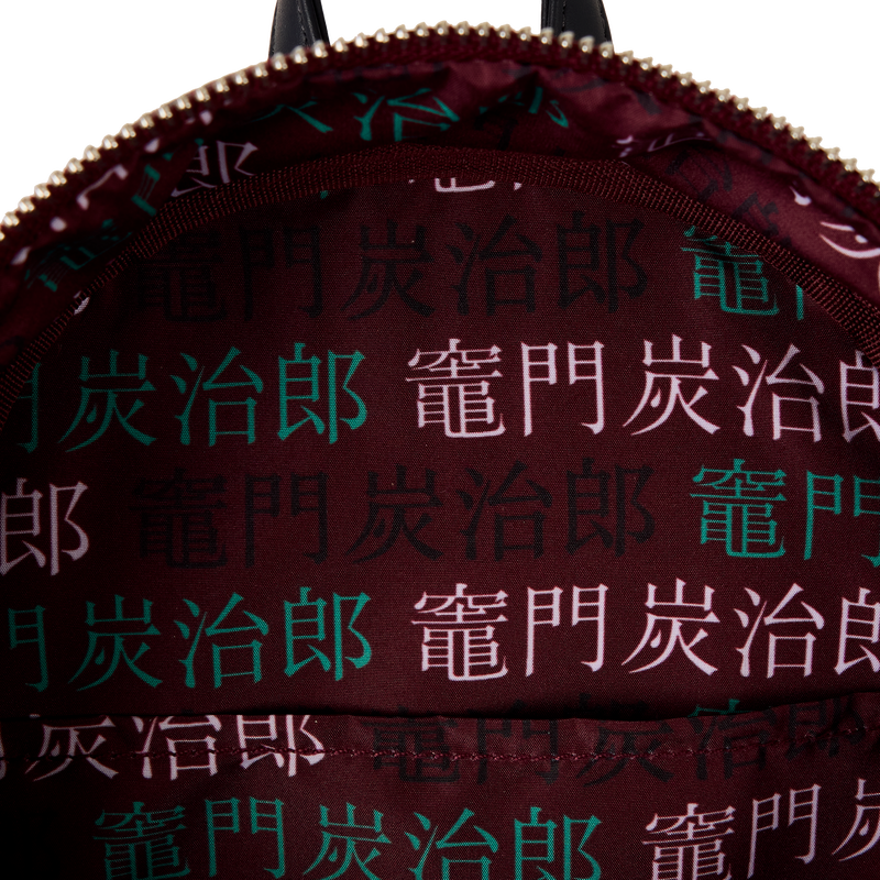 Interior view of Loungefly Demon Slayer Nezuko Kamado cosplay mini backpack showing printed character name pattern on fabric lining