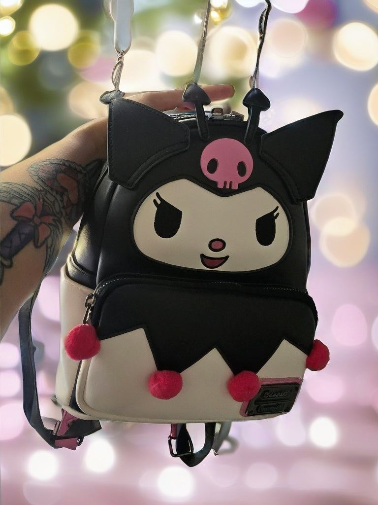 Sanrio Kuromi mini backpack in black and cream with pink pom-poms and a jester face design