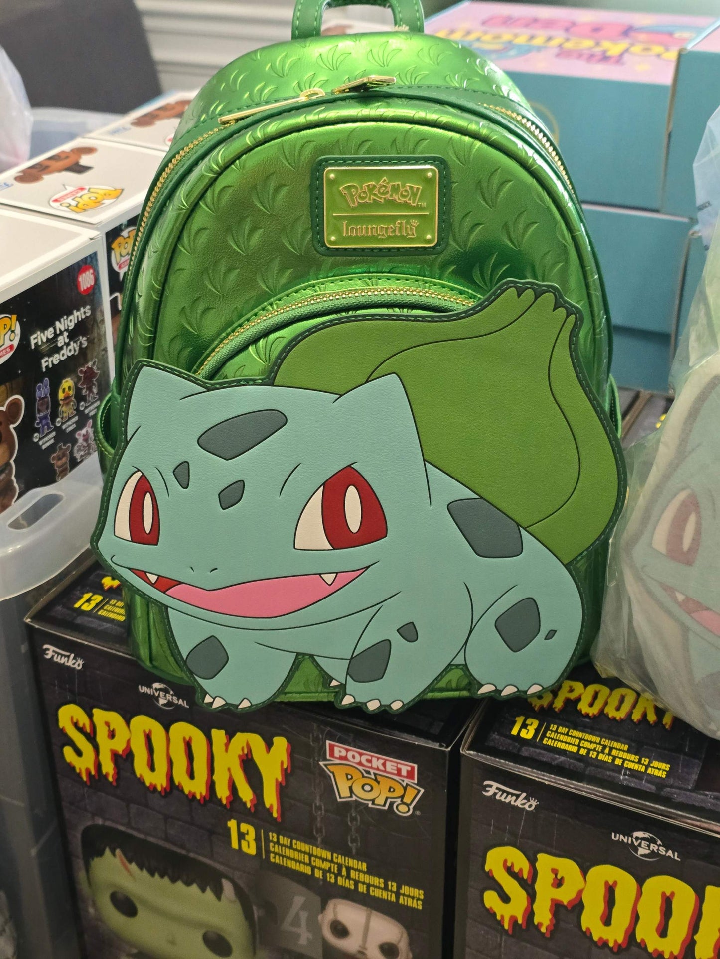 Green metallic Pokémon Loungefly Bulbasaur mini backpack with embossed leaf pattern and Bulbasaur applique