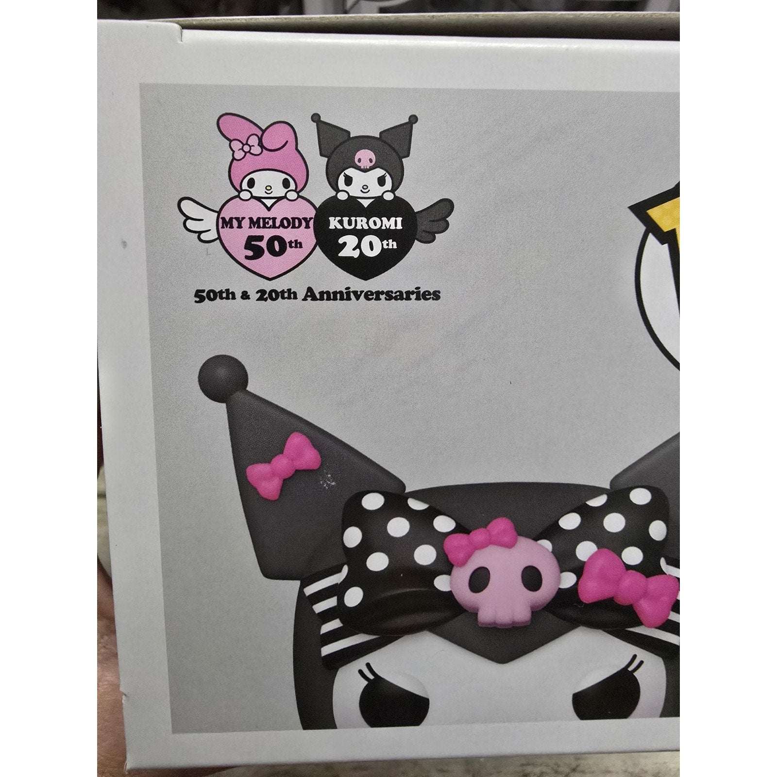 Sanrio Kuromi 20th Anniversary Funko Pop! vinyl figure with pink and black polka dot bow and skull accessory on packaging box