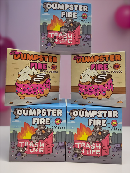 Assorted Dumpster Fire vinyl figure collectible boxes featuring cartoon designs of fire, dumpsters, and donuts with pink frosting and sprinkles.